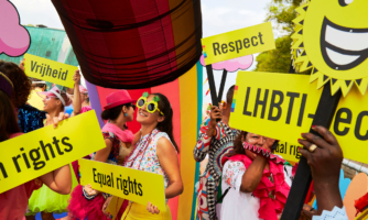 People hold up signs in celebration of human rights.