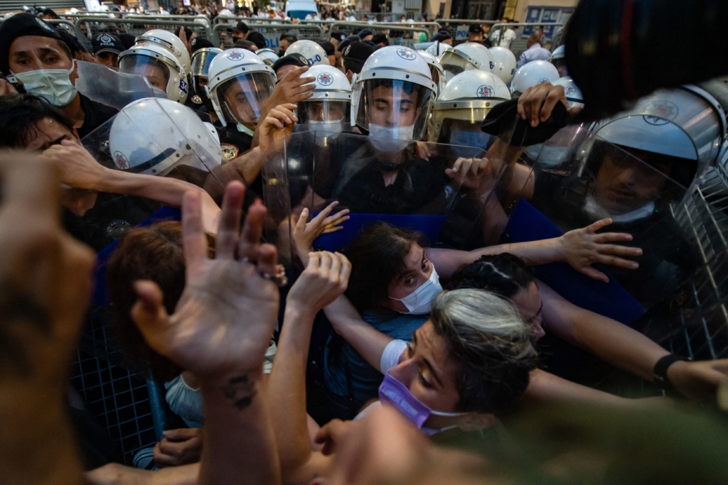 Women demonstrators clash with Turkish police as they protest against Turkey's decision to withdraw from the Istanbul Convention, in Istanbul,on July 1, 2021. - Police fired tear gas at protesters in Istanbul demonstrating against Turkey's controversial exit on July 1, 2021 from a treaty combatting femicide and domestic abuse.
