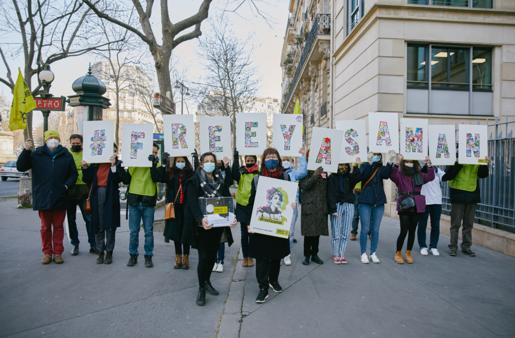 Activists hold up letter spelling the name of Iranian women's activist Yasaman Aryani as they call for her freedom.